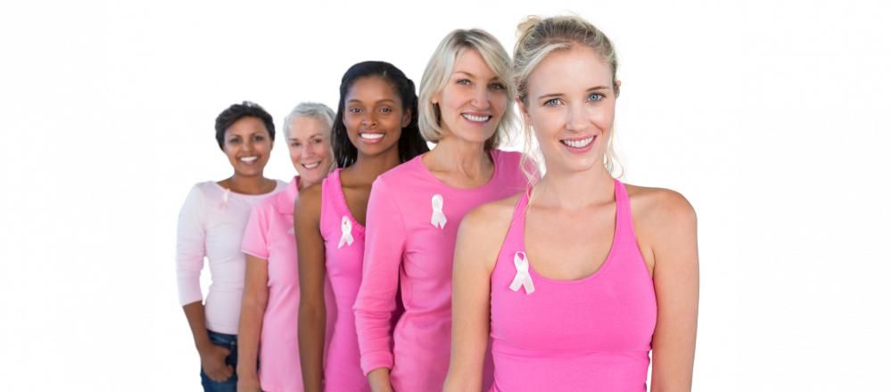 women wearing pink shirts with breast cancer ribbons