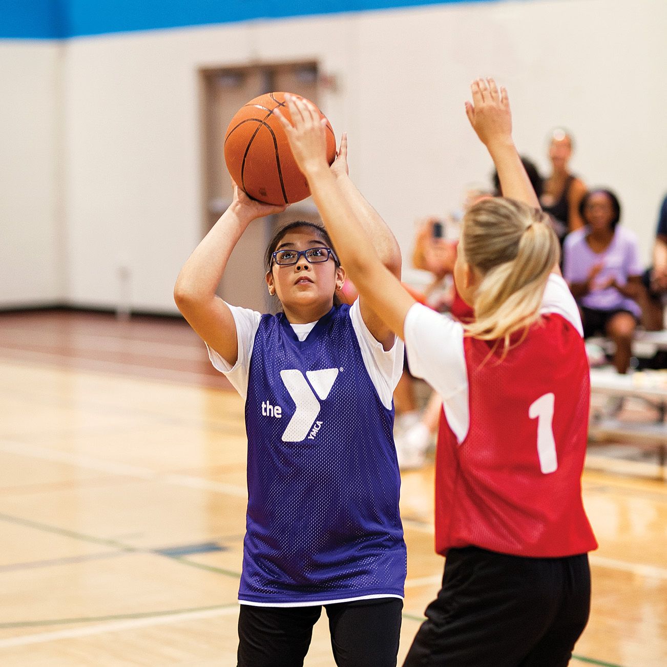 two girl's in Y shirts playing basketball