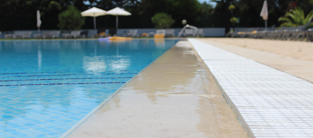 An image of the side of an outdoor pool available for local families at the YMCA. 