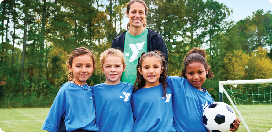 ymca youth and family programs mom and group of girls on a youth soccer team