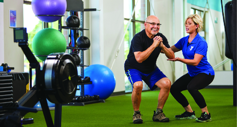 YMCA Exercise for Parkinson's Program participant works on balance with a ymca personal trainer