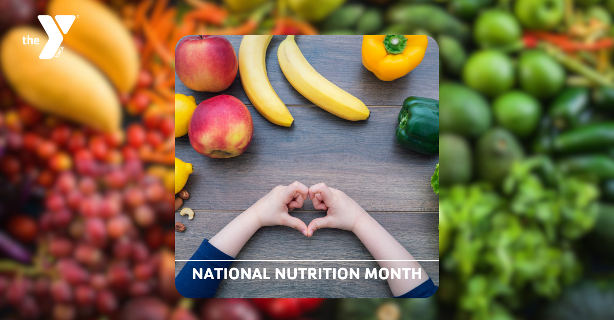 kids hand making a heart surrounded by fruit and vegetables with text that says "national nutrition month"