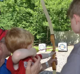 Dad and sons at the archery range
