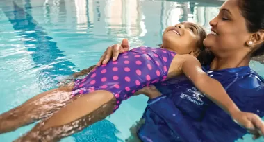 A child learns how to back float at a ymca swimming lesson
