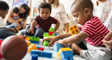 babies playing with blocks in an early learning readiness program