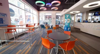 An image of the inside of one of the fresh and modern St. Louis YMCA locations. The lounge area and check-in desk are visible.