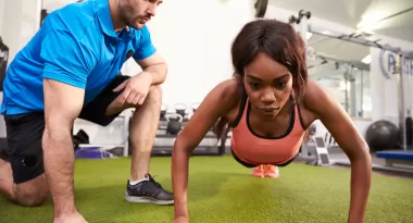 A woman performs a plank during a personal training session