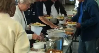 A group of active older adults at a ymca potluck