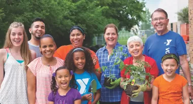 a group of ymca volunteers in a community garden