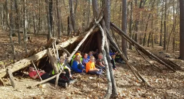 Kids in woods learning about outdoor education