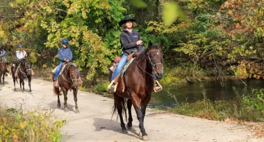 adults on a trail ride in the fall