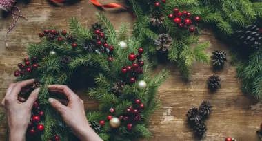 person making a christmas wreath