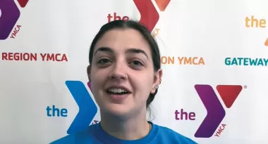 Hayley in front of a Y logo wall