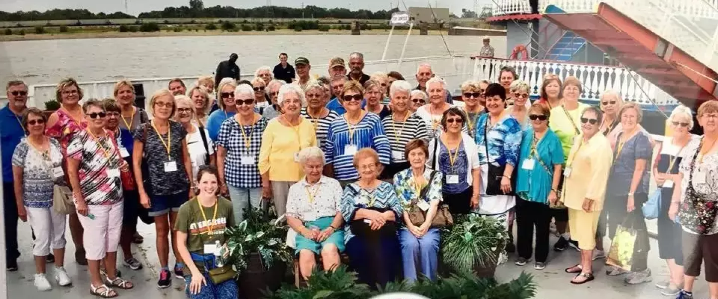 A group of active older adults on a boat during a Monroe County YMCA trip