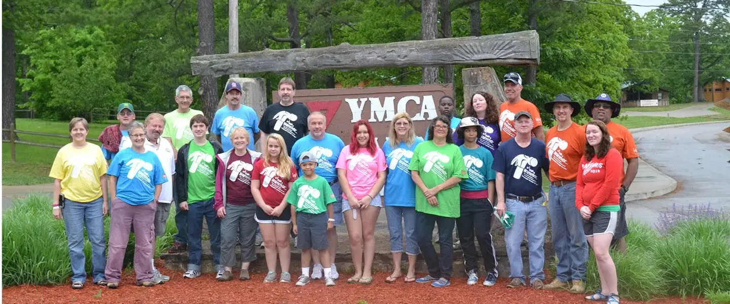 Group of alumni in from of YMCA sign