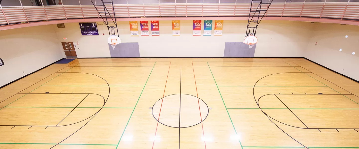 One-court gymnasium with 6 basketball hoops. Indoor track running overhead.