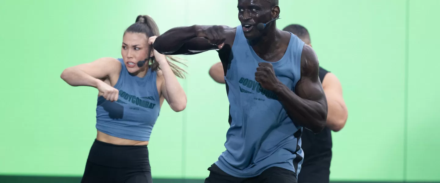 Les Mills BODYCOMBAT instructors demonstrating workout