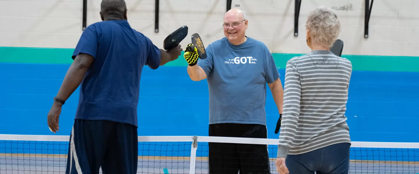 A group of older adults playing pickleball at the ymca