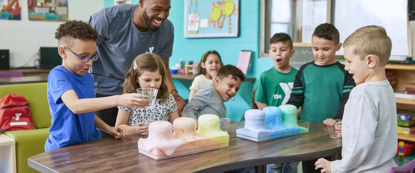 Kids having fun doing a science experiment in a ymca before and after school program