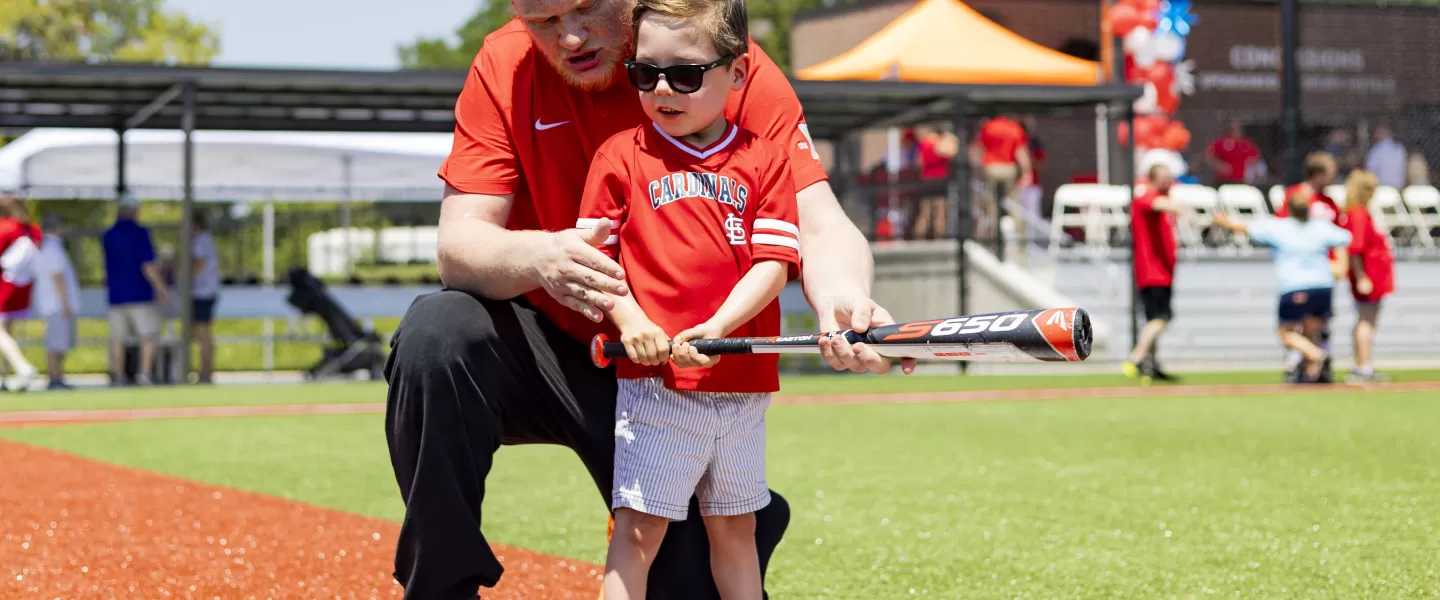 ymca adaptive baseball participant and volunteer on adaptive sports complex field