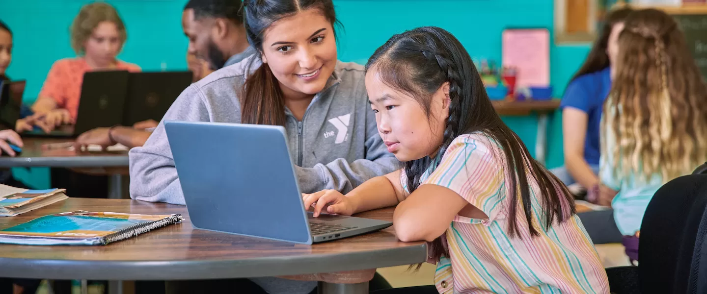 YMCA Y Club Before & After School Program Staff Helping Child With School Homework