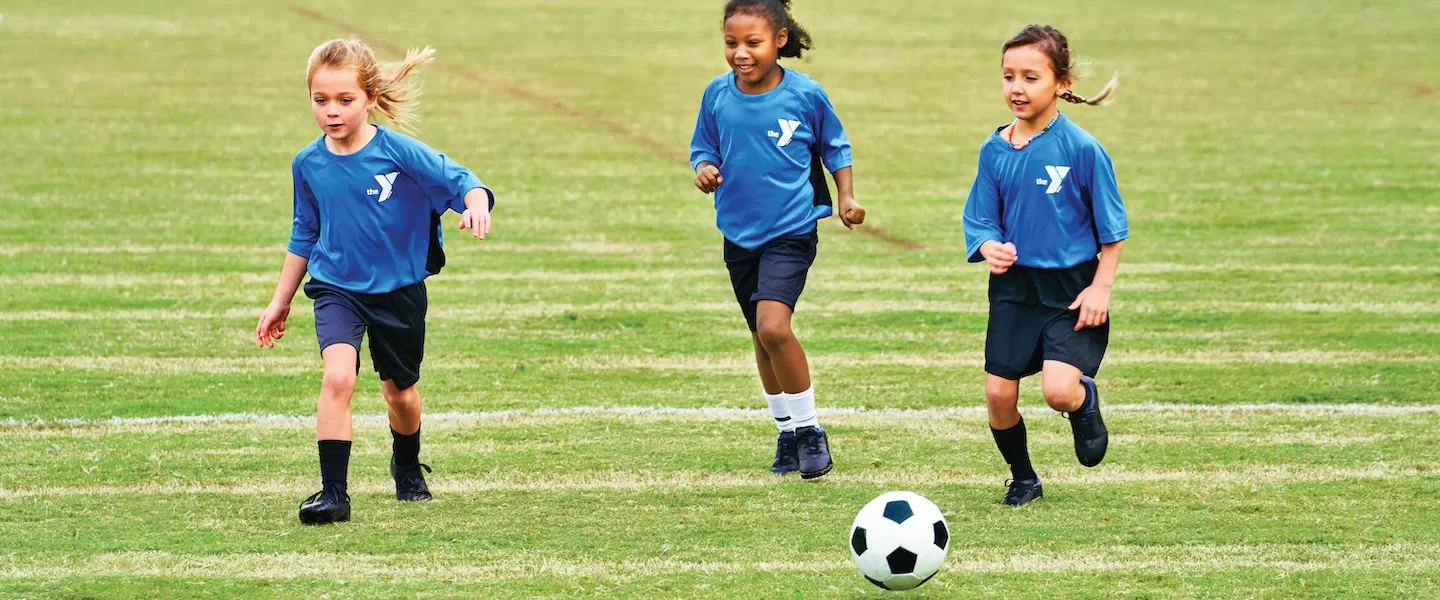 young girls playing soccer at the ymca