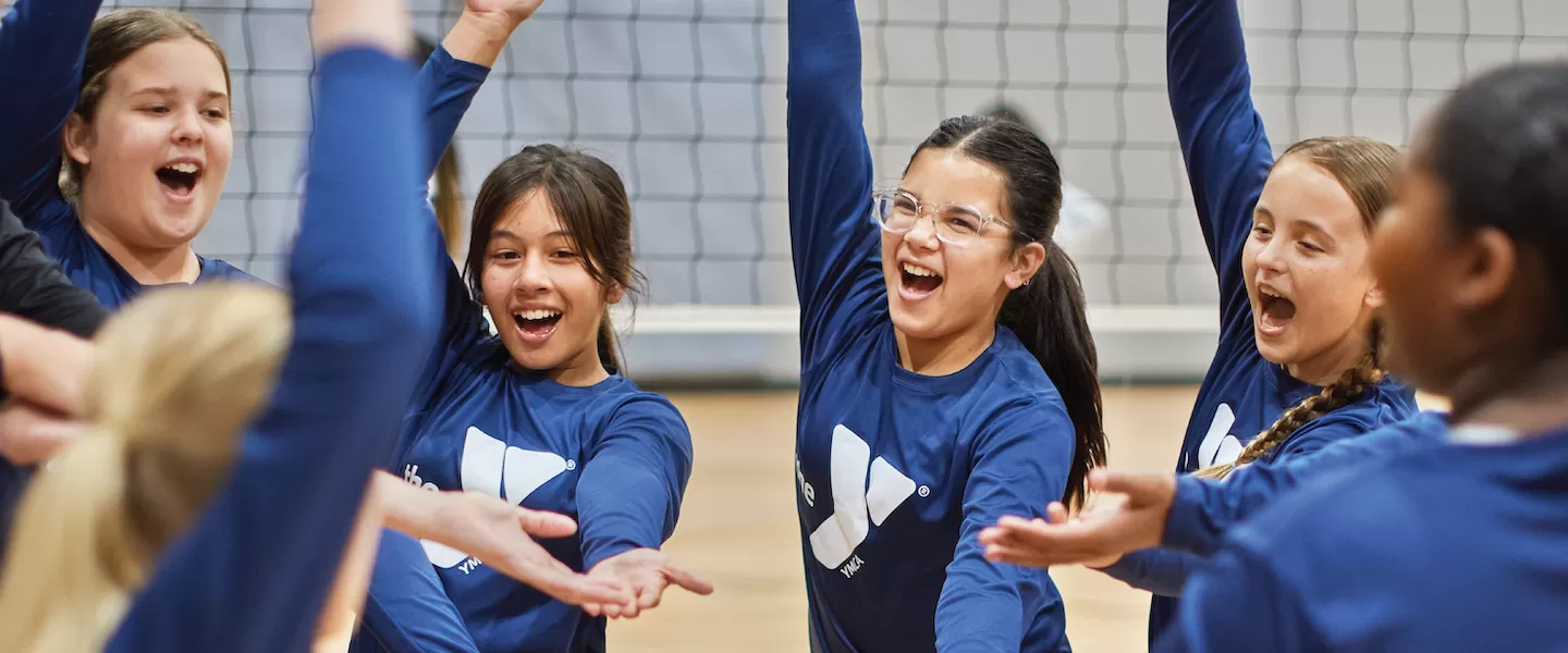 young girls playing volleyball at the ymca