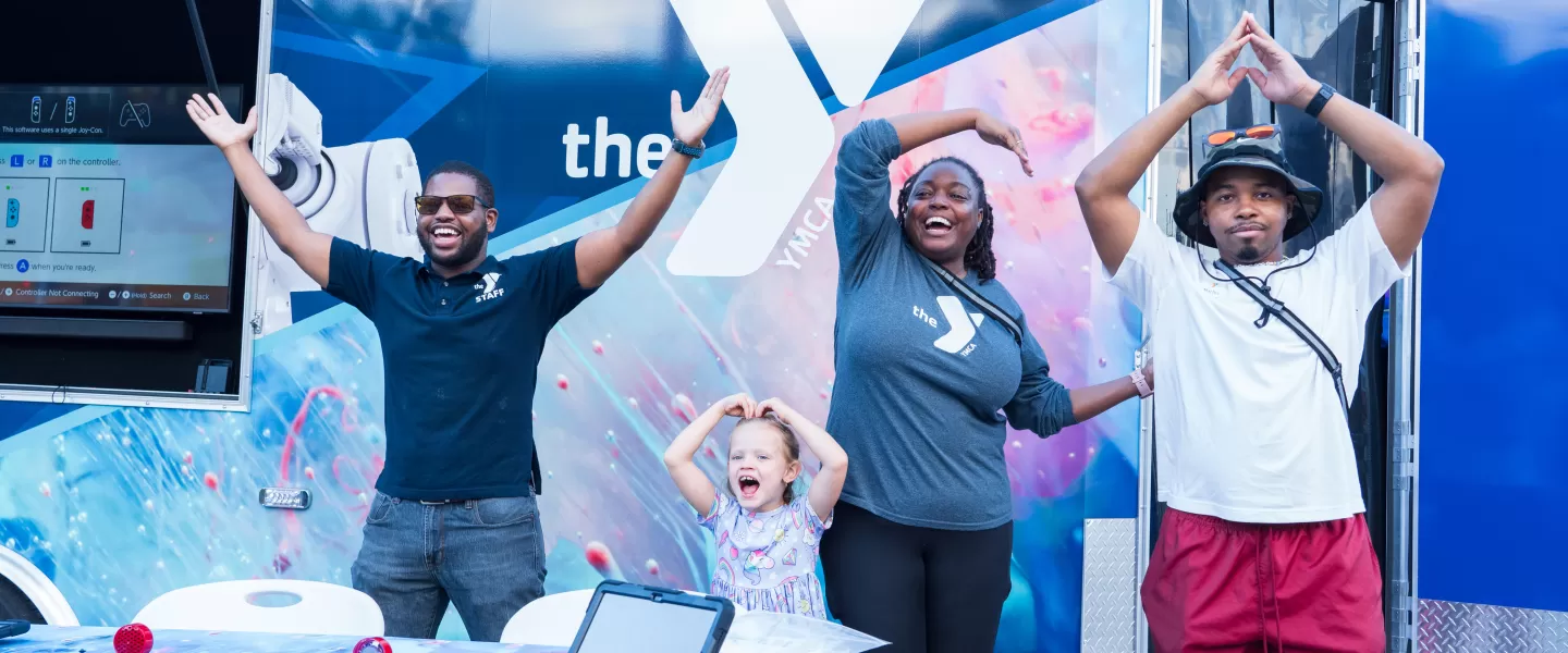 kids and staff posing in front of the Mobile Y