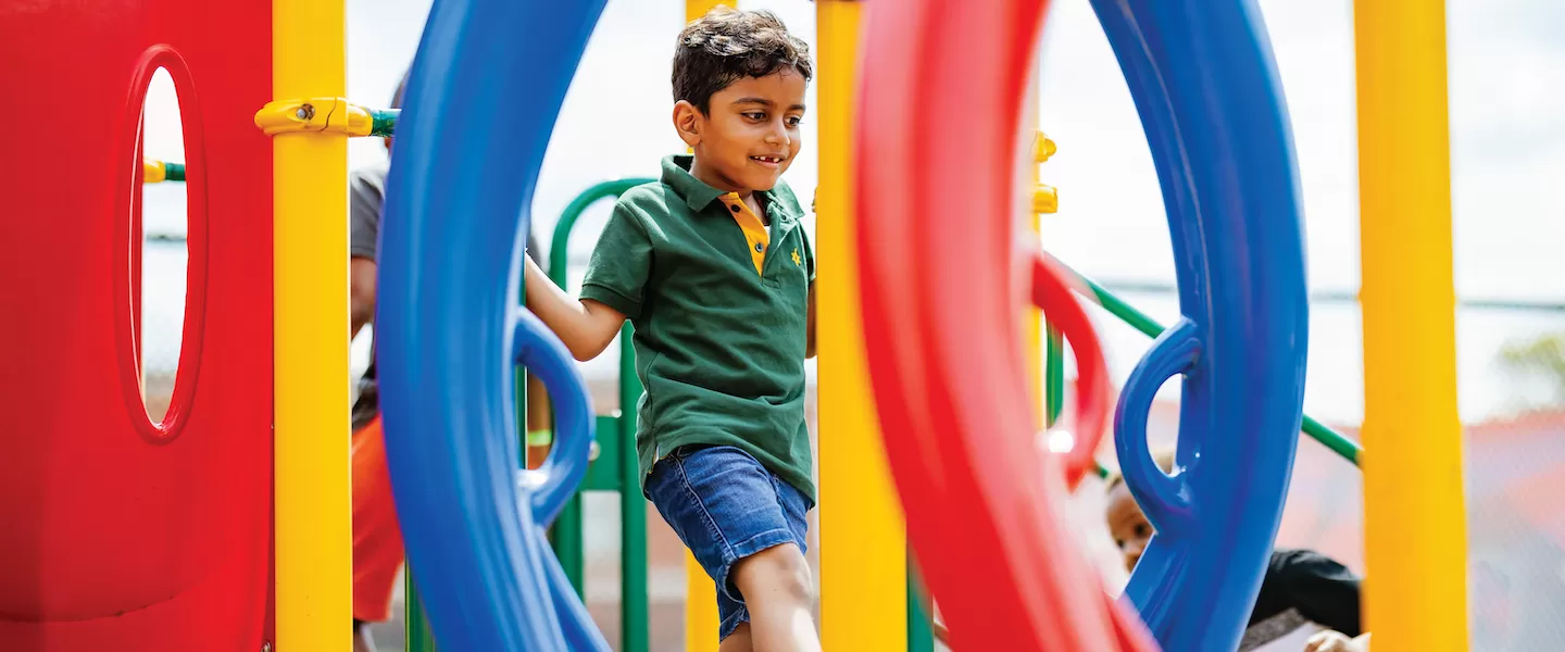 young boy on playground at ymca summer day camp