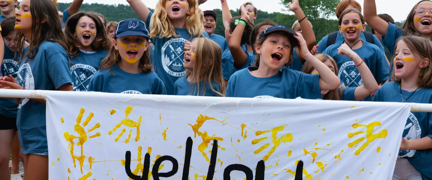 YMCA Camp Lakewood campers, part of the "Yellow Group" celebrating showing YMCA Camp Lakewood spirit