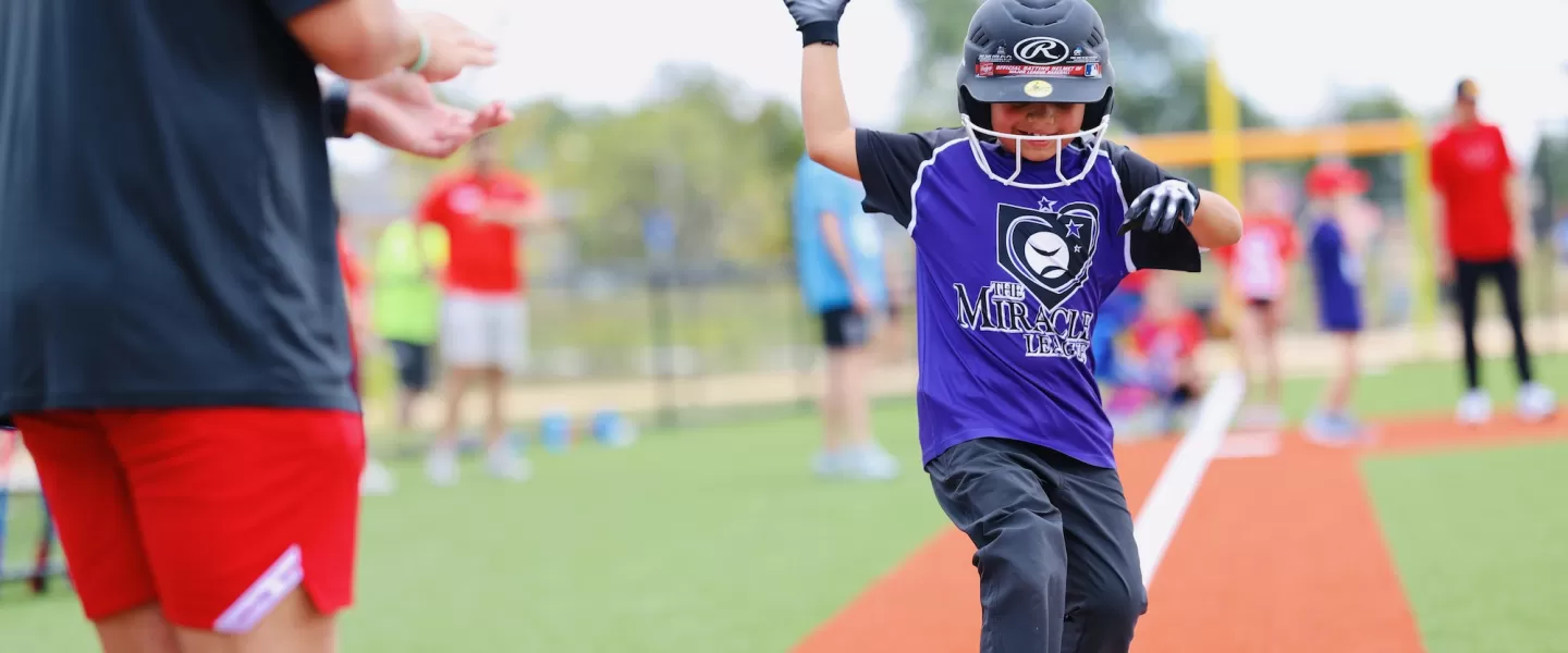 YMCA Adaptive Sports Complex Boy Scoring with Baseball Hat