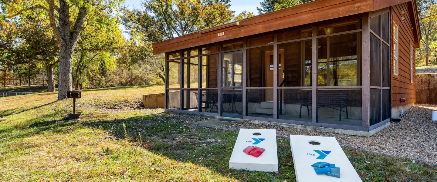 YMCA Trout Lodge in Potosi, MO Bluff View Cabin Exterior with Screened Porch, patio furniture, and grill
