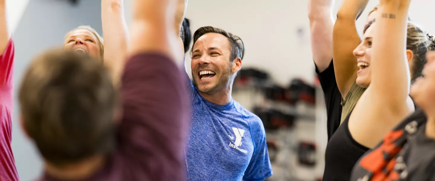 YMCA Group Exercise class participants celebrating the completion of a LesMills BODYPUMP class.
