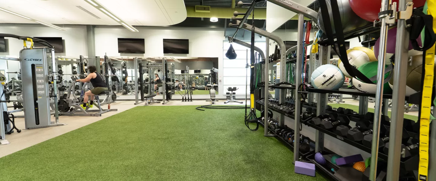 Newly renovated functional fitness area at Four Rivers YMCA featuring turf, weight machines, and functional training equipment