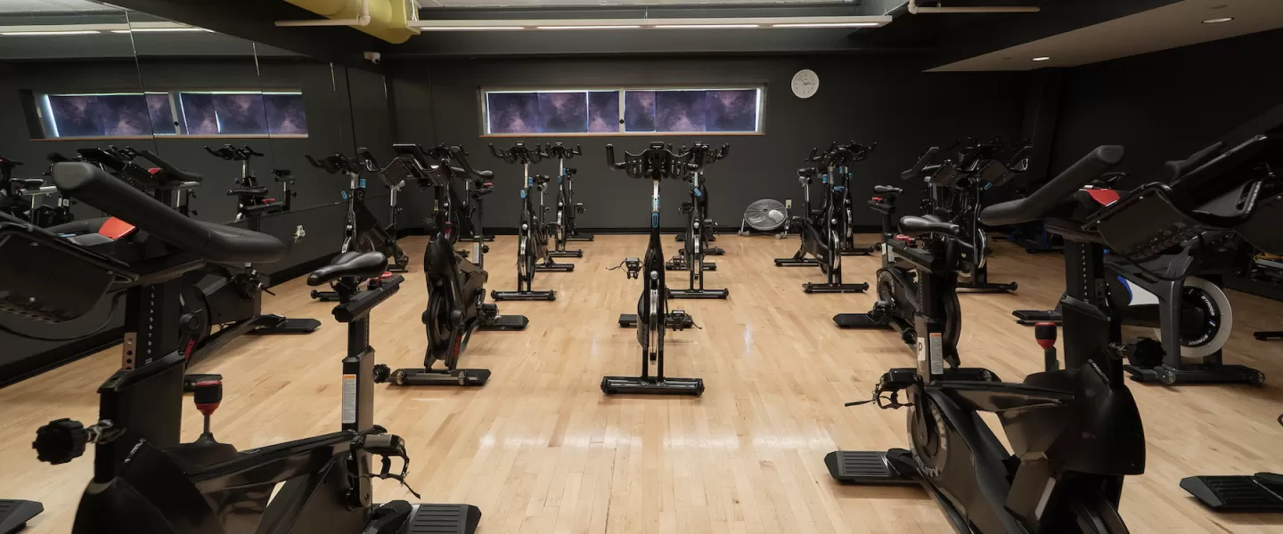 Upgraded indoor cycling studio at Four Rivers YMCA with new spin bikes and refreshed lighting and layout