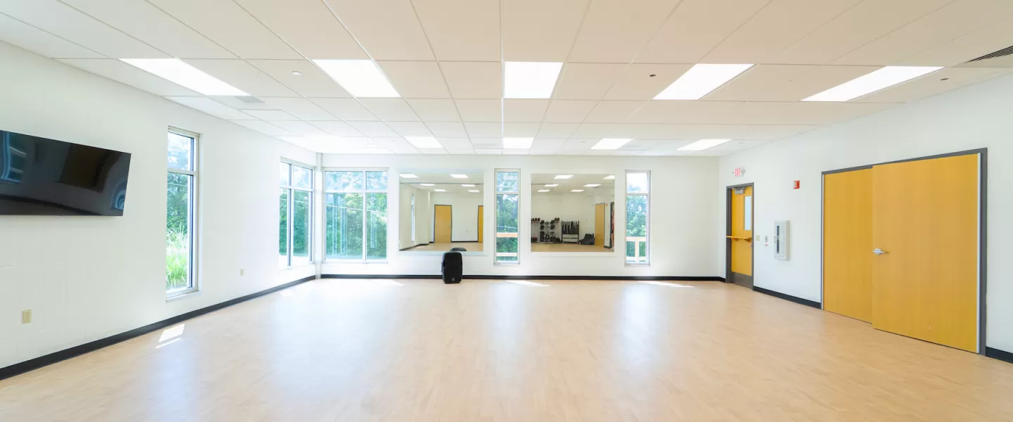 Renovated group exercise studio at Four Rivers YMCA with new flooring, fresh paint, and Les Mills BODYPUMP equipment