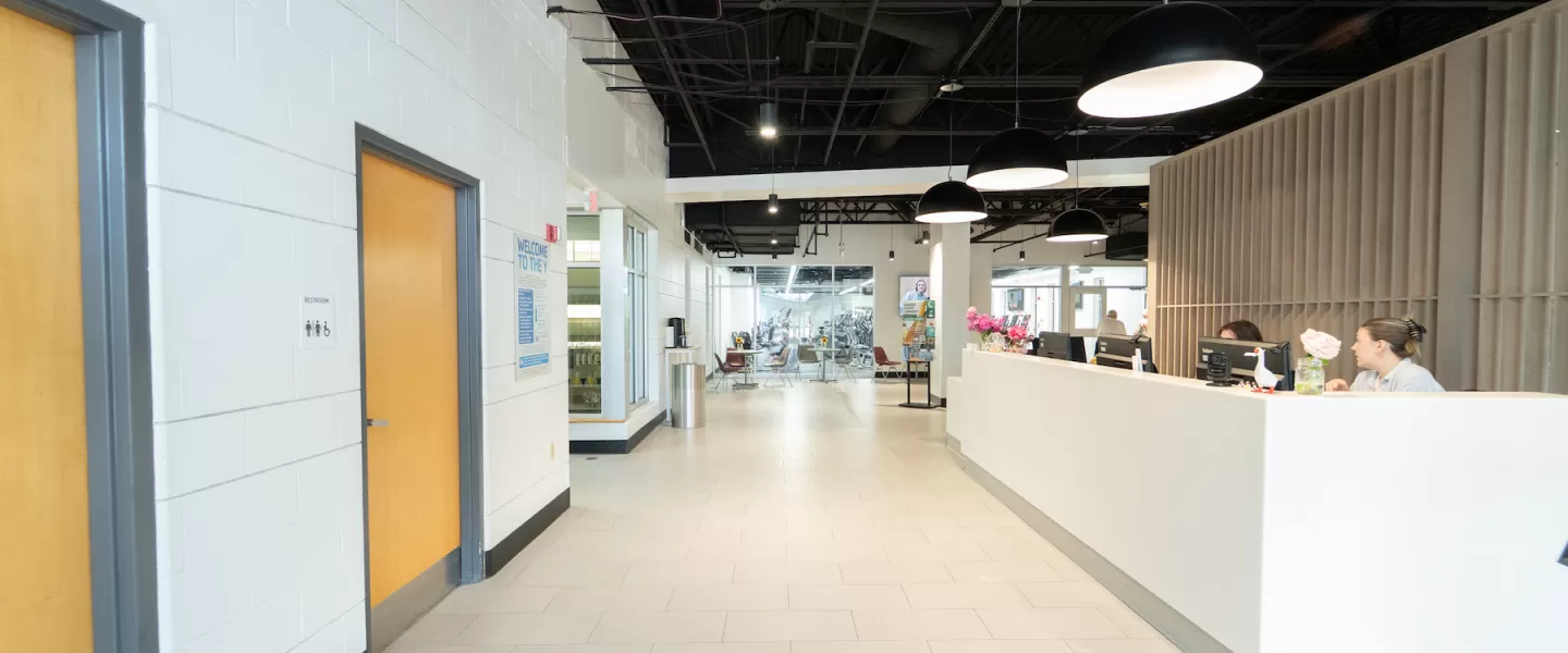 Modernized lobby at Four Rivers YMCA featuring new flooring, updated Welcome Center desk, fresh paint, and new lounge furniture