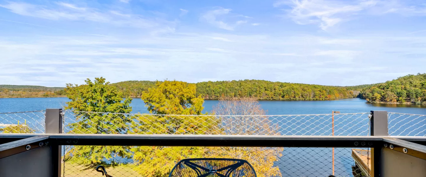 Private patio with two chairs and small table overlooking the lake from the second-floor Loft Room