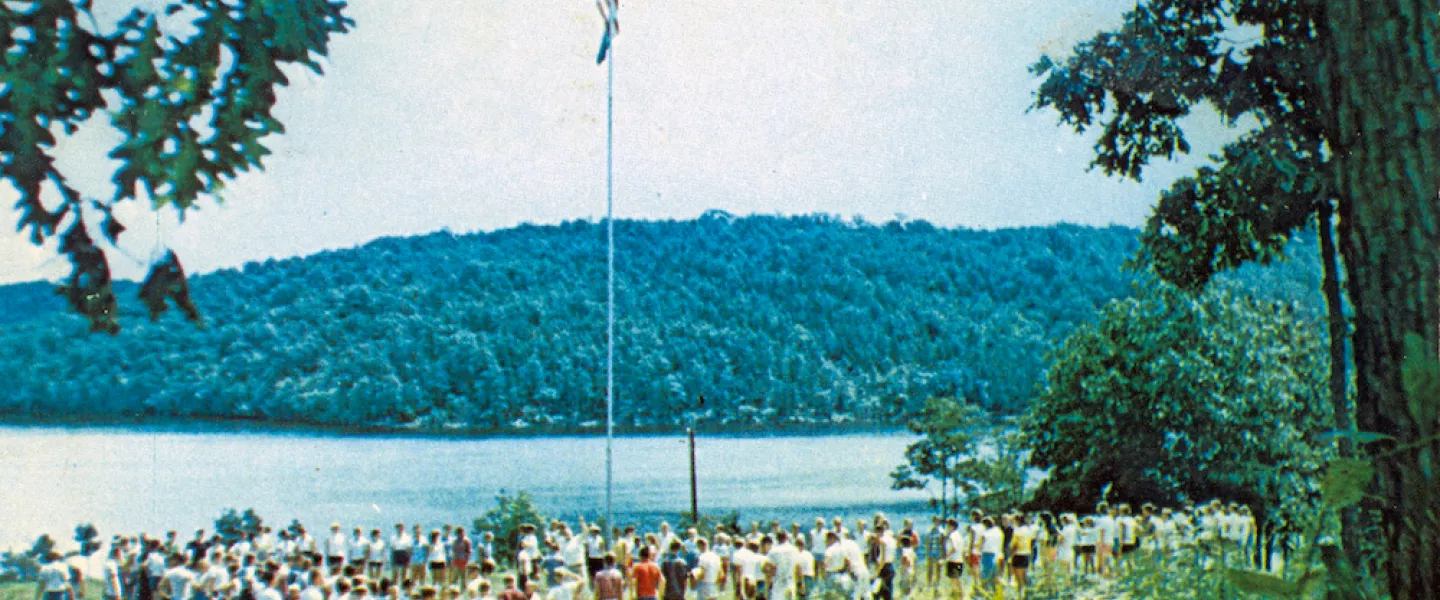 A panoramic photograph of the newly completed 360-acre Sunnen Lake at YMCA Trout Lodge in 1949 and boys Camp Lakewood group standing at the lake's edge.