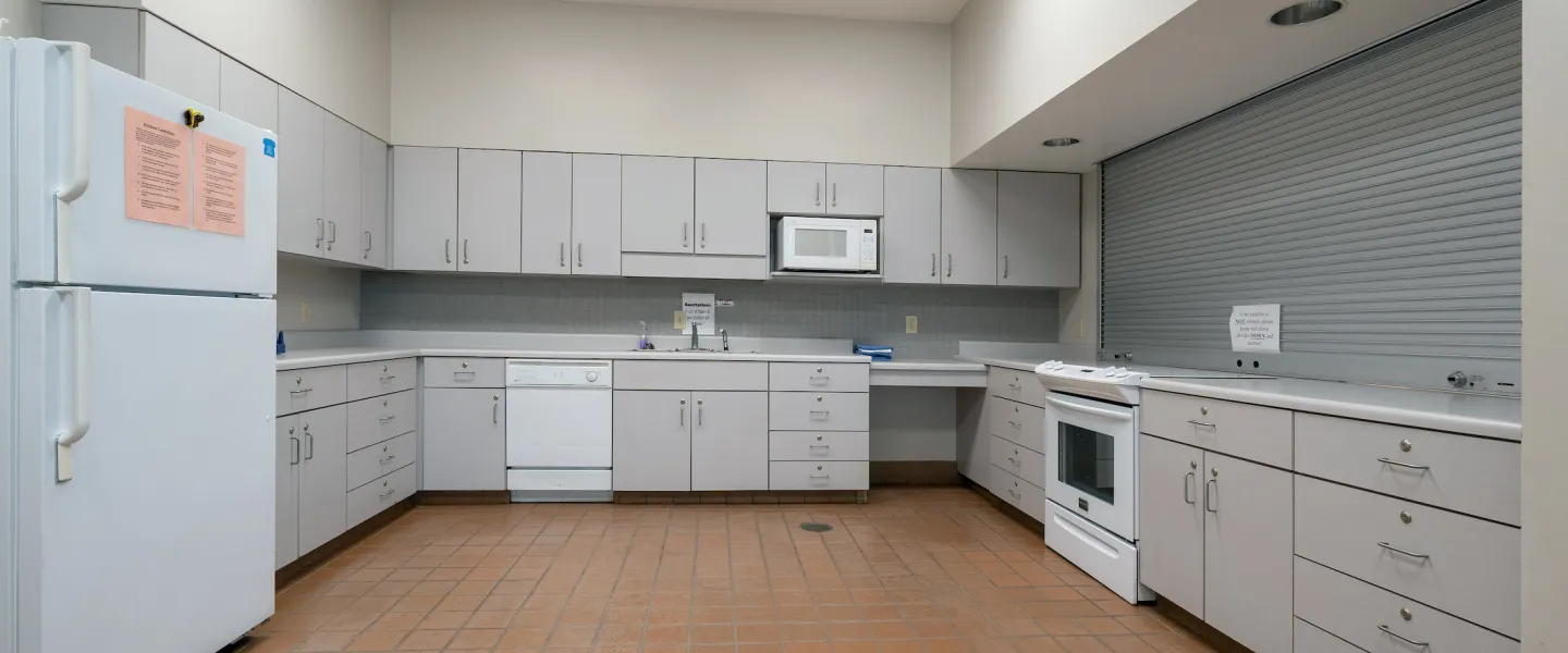 Ste. Genevieve County YMCA kitchen with fridge, stove, and sink for events, parties, and gatherings
