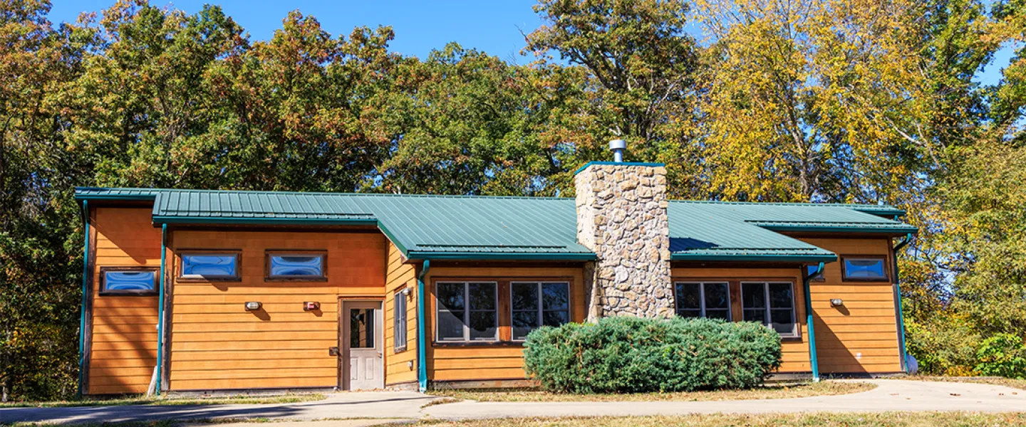 A modern, dorm-style Main Camp cabin with air conditioning and a welcoming front porch.