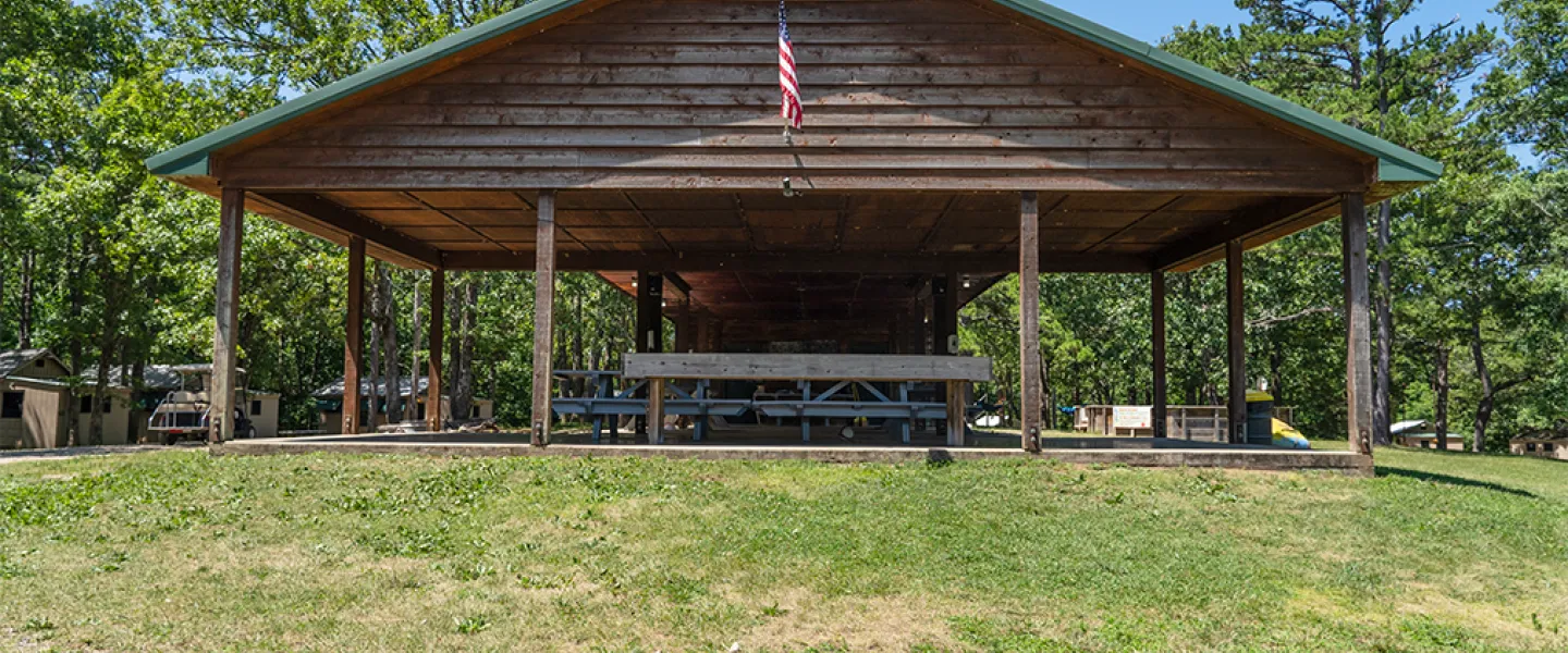 The large, covered Main Camp pavilion with picnic tables, used for group activities and cabin bonding.