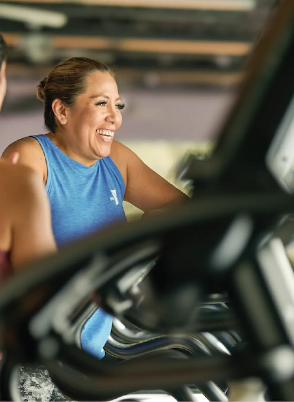 Two Females on YMCA Corporate Memberships Working Out on Elliptical Machines