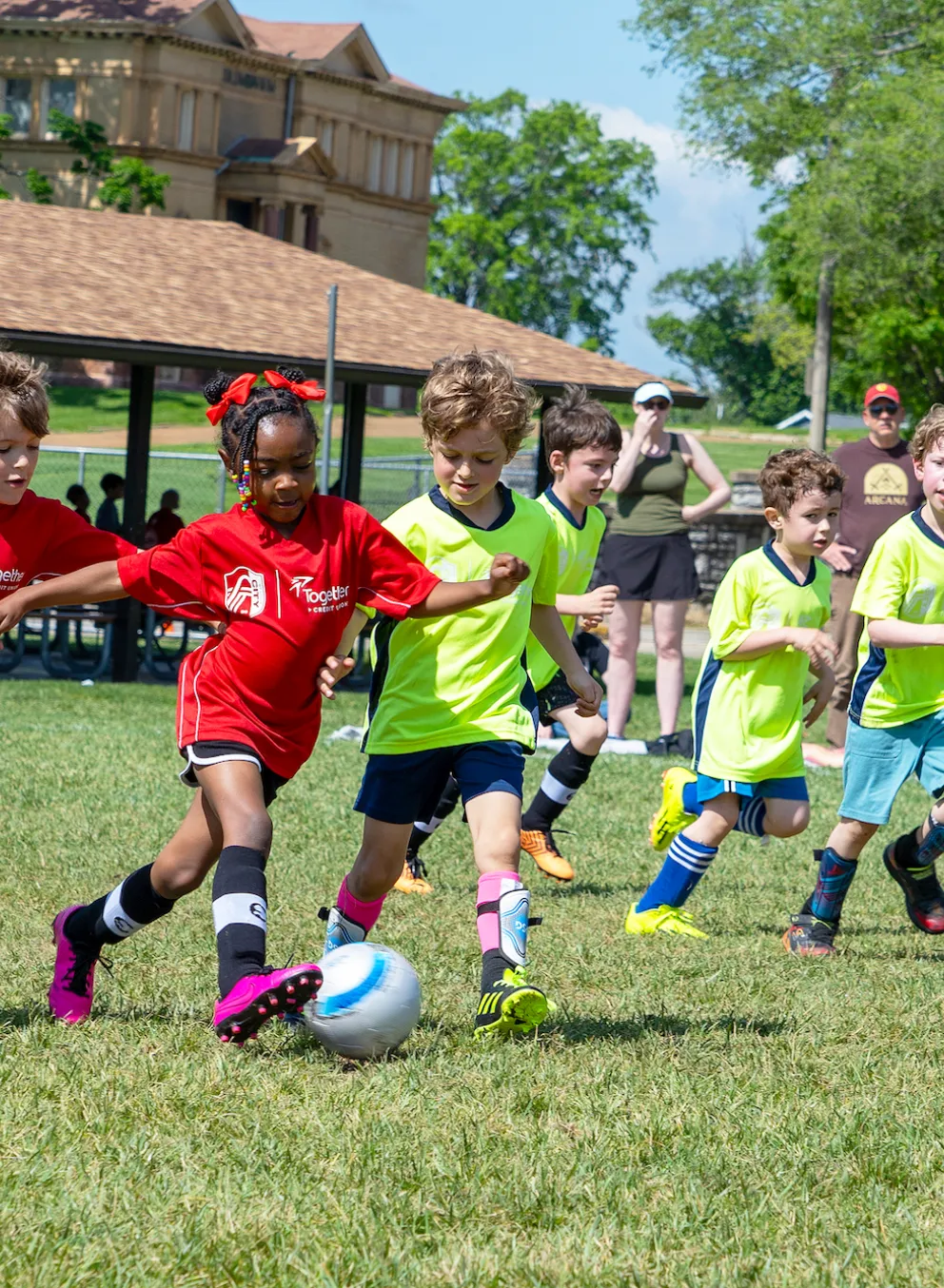 Young soccer players compete in a friendly match wearing newly branded CITY SC and Gateway Region YMCA jerseys.