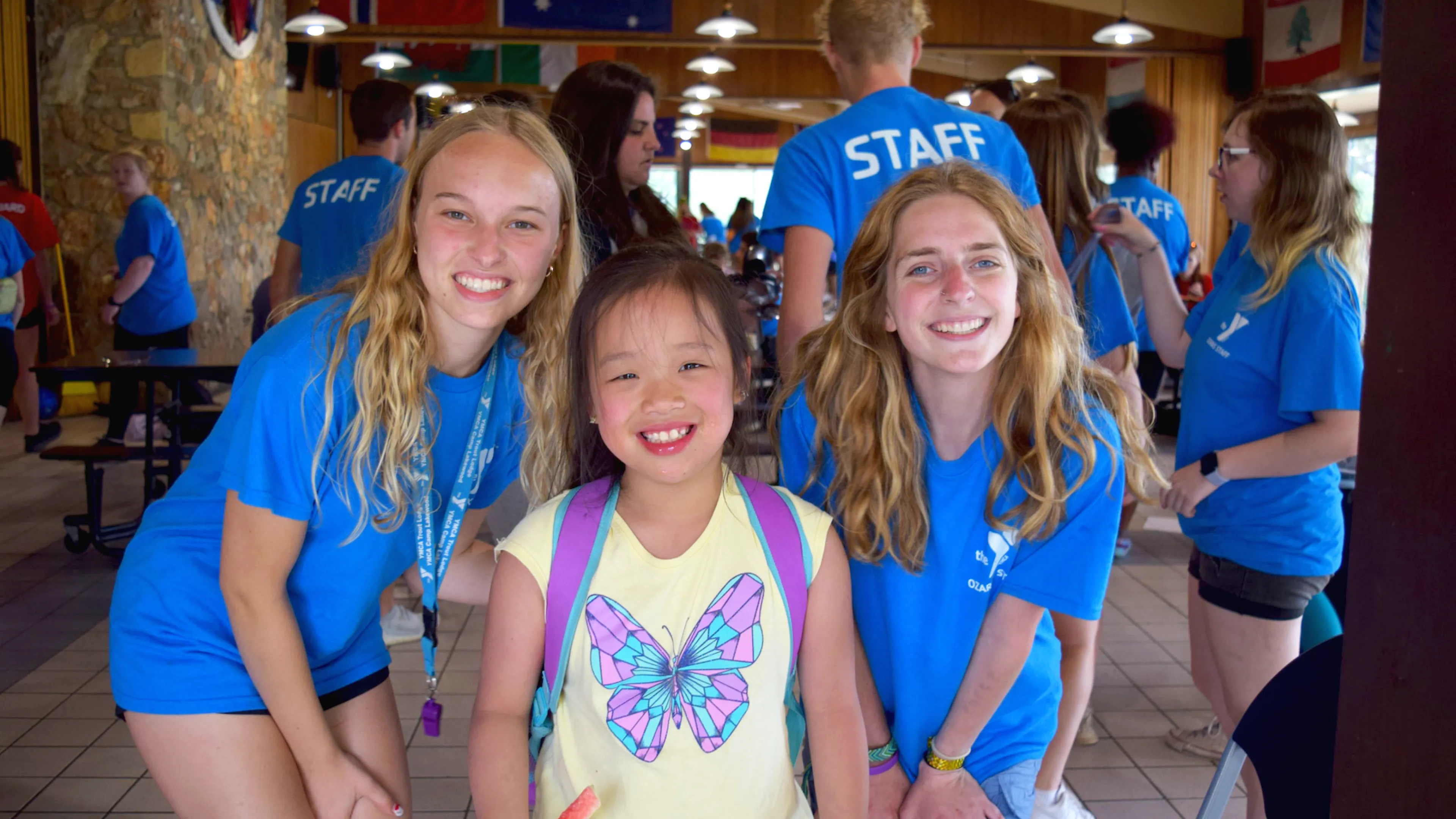 ymca camp lakewood camper with two counselors smiling