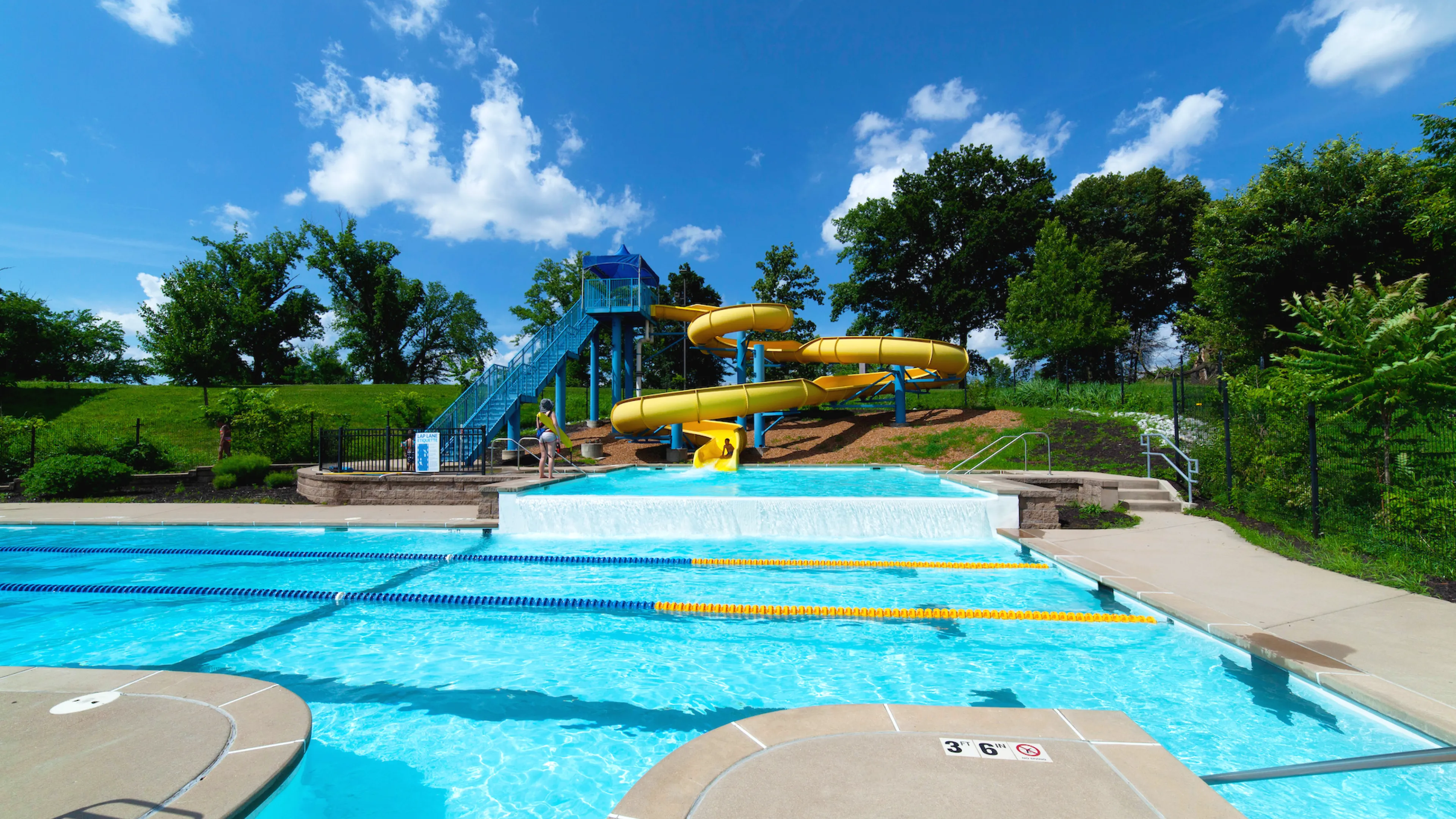 Carondelet Park Rec Complex Gym St. Louis, MO Outdoor Aquatic Center featuring a 2.5-story yellow water slide