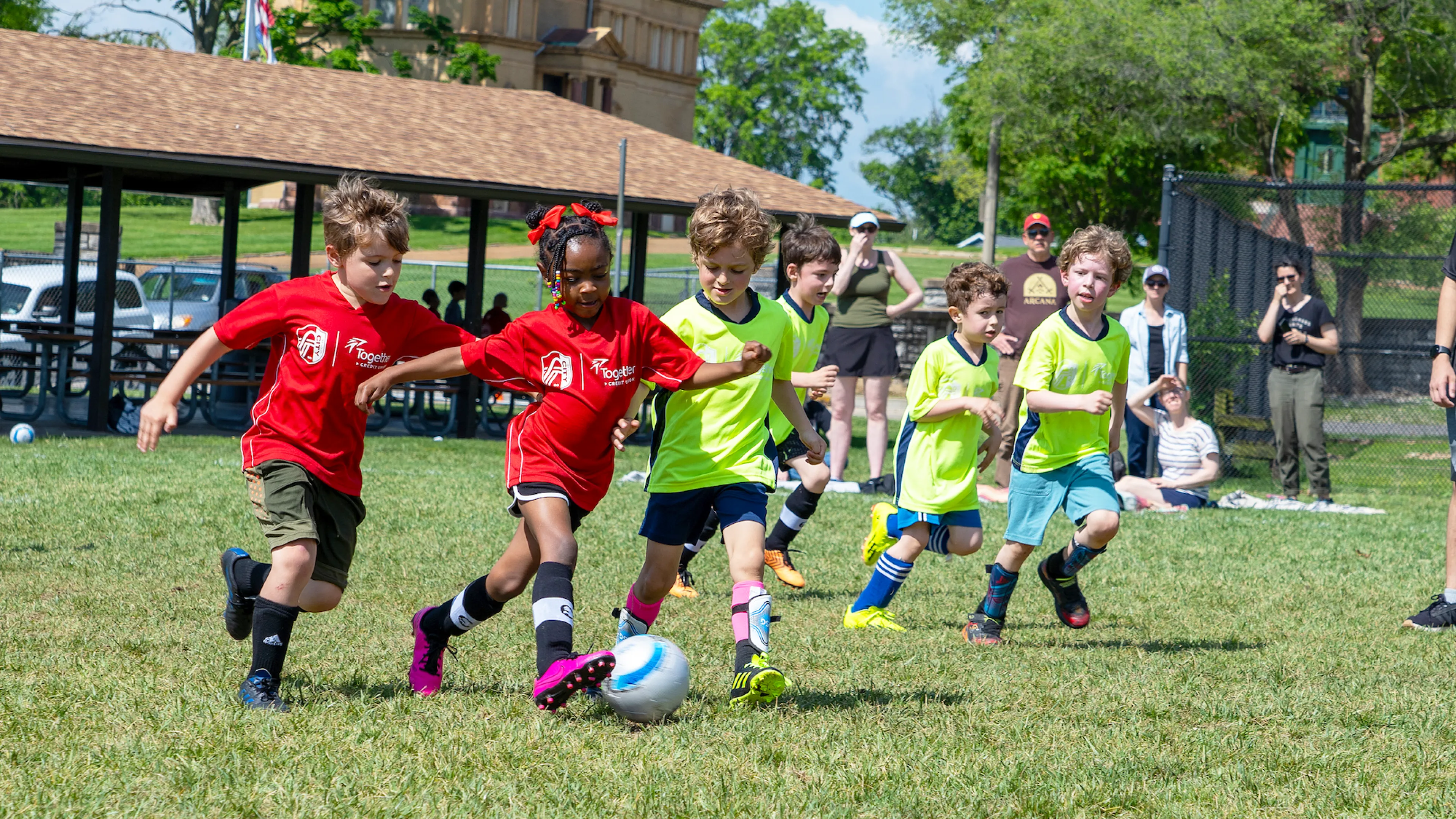 Young soccer players compete in a friendly match wearing newly branded CITY SC and Gateway Region YMCA jerseys.