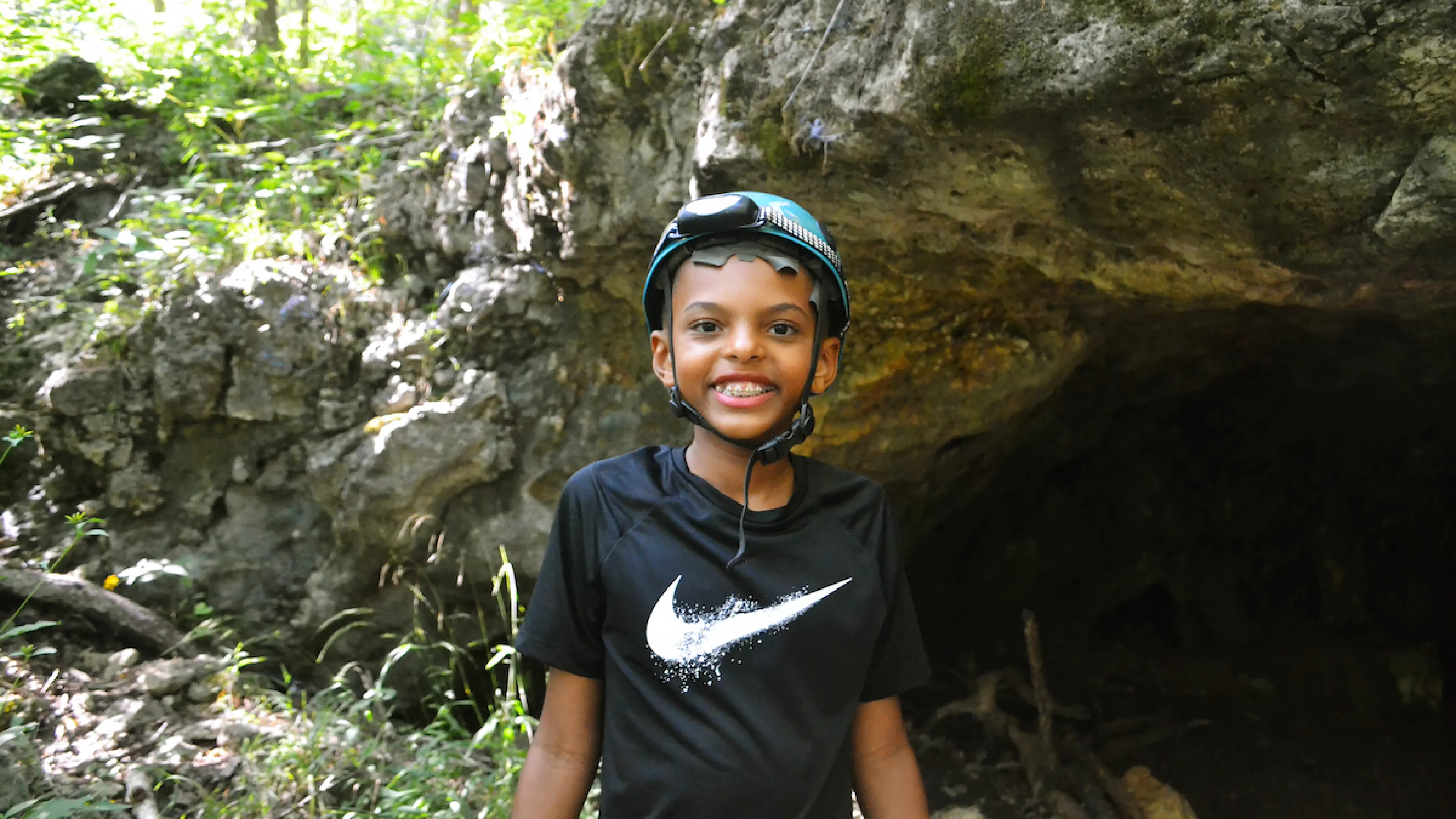 YMCA Camp Lakewood Camper wearing a helmet on a cave excursion