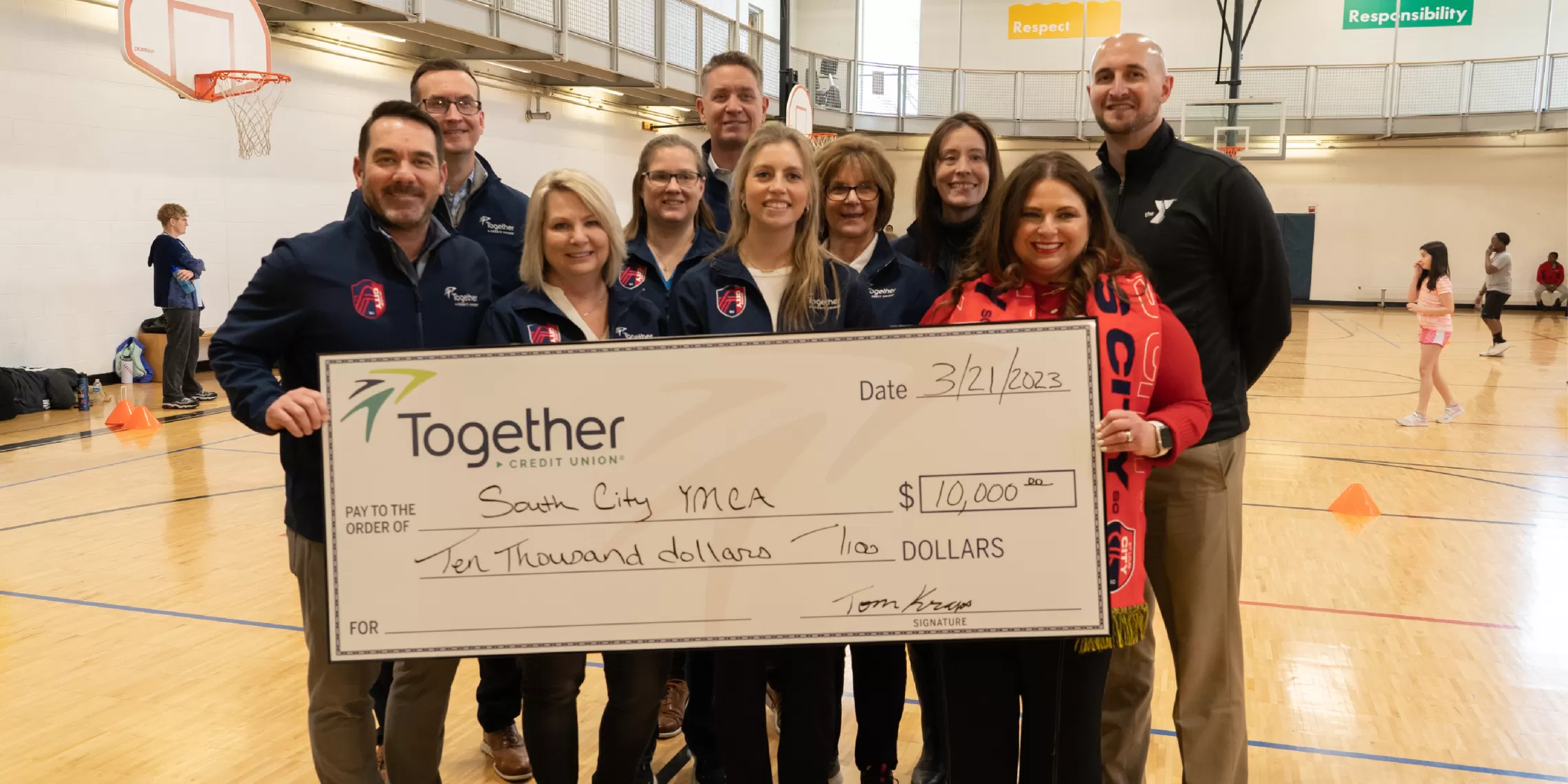 St. Louis City SC, Gateway Region YMCA, and Together Credit Union holding check