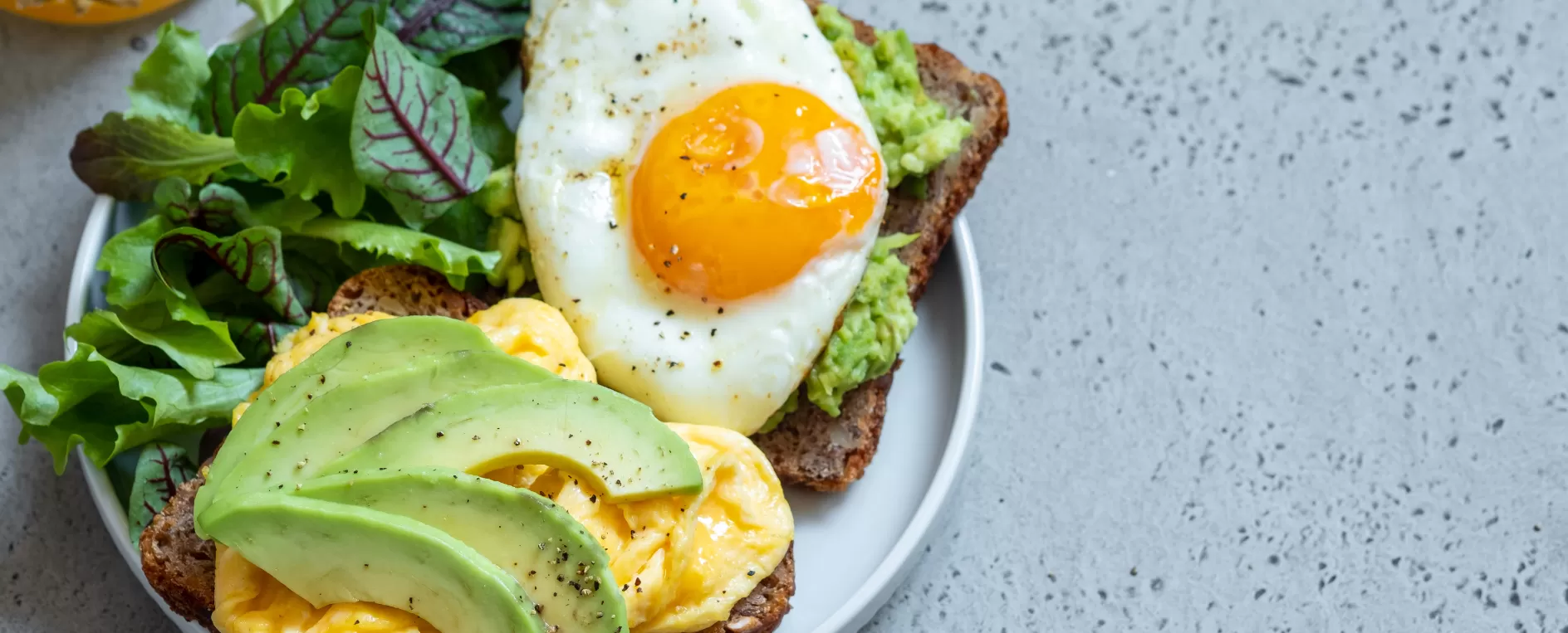 breakfast plate with eggs, avocado, and toast